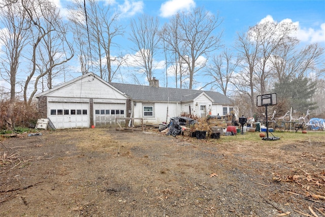 exterior space featuring a garage and an outdoor structure