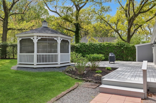 view of green lawn featuring a gazebo and a wooden deck