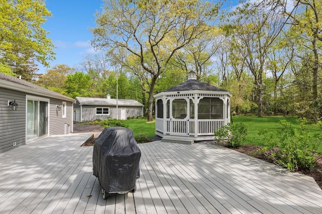wooden deck with a gazebo, a yard, and view of wooded area