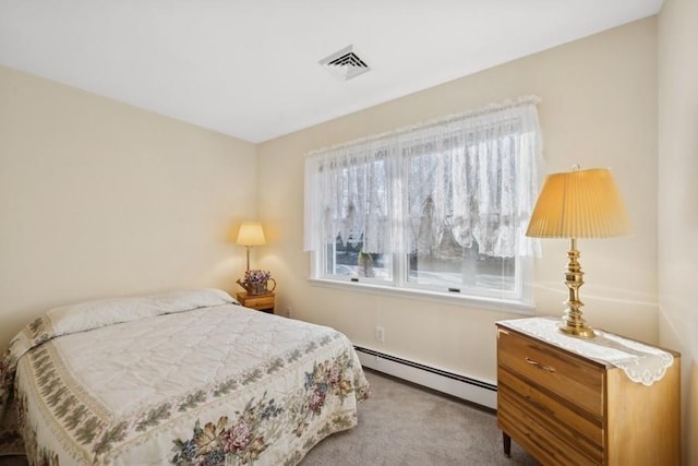 carpeted bedroom with visible vents and a baseboard heating unit