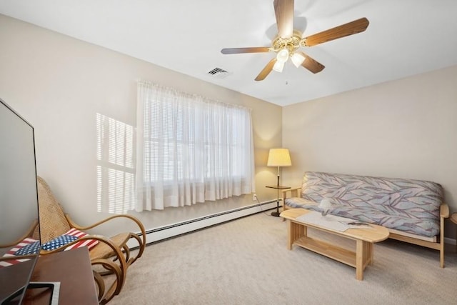 sitting room featuring carpet floors, a ceiling fan, visible vents, and a baseboard heating unit