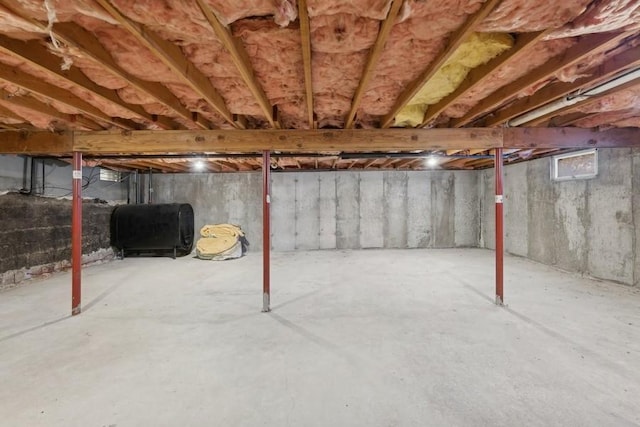 unfinished basement featuring heating fuel