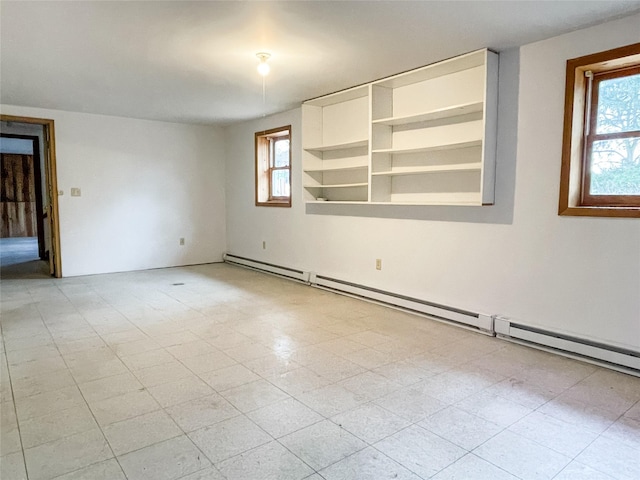 unfurnished room with a healthy amount of sunlight and a baseboard radiator