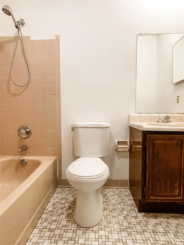 full bathroom featuring vanity, toilet, and tiled shower / bath