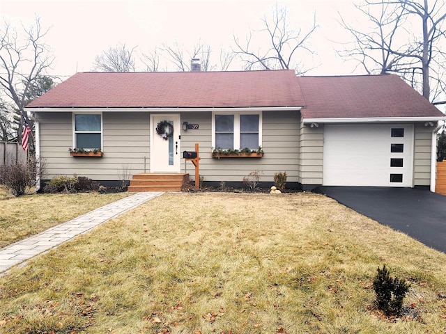 ranch-style house featuring a garage and a front yard