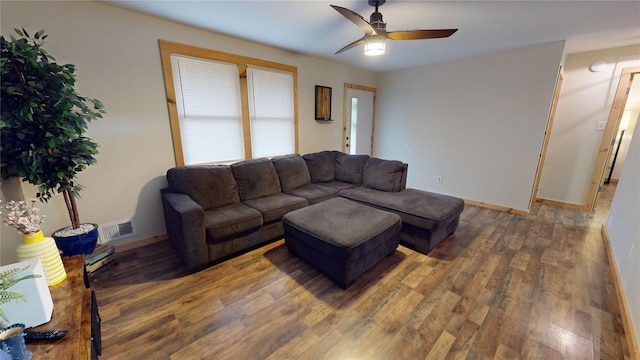 living room featuring dark hardwood / wood-style floors and ceiling fan