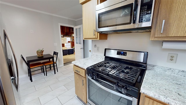 kitchen with light brown cabinetry, crown molding, light stone countertops, and appliances with stainless steel finishes