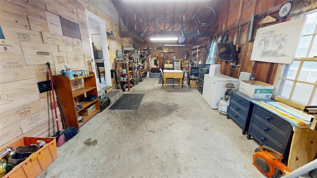 basement with a workshop area and wood walls