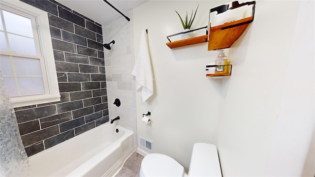 bathroom featuring toilet and tiled shower / bath combo