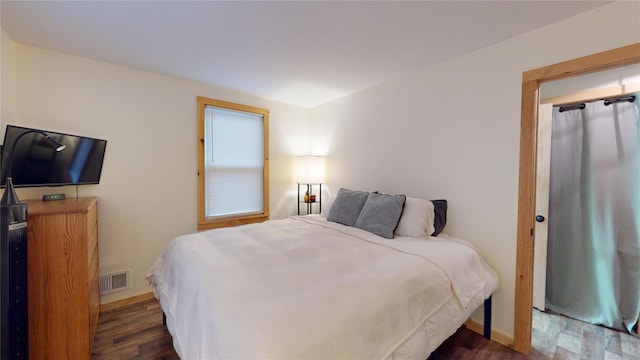 bedroom featuring dark wood-type flooring