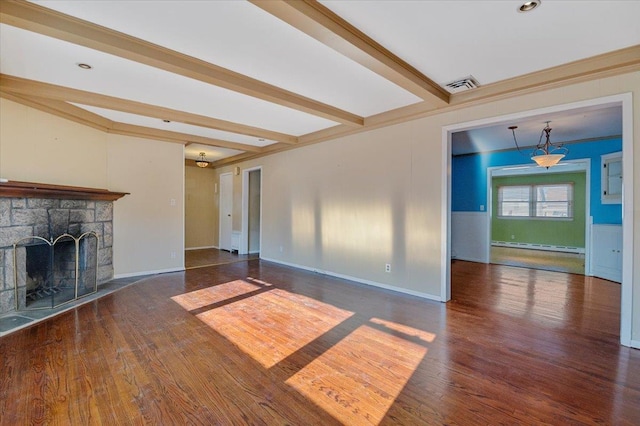 unfurnished living room featuring beamed ceiling, dark hardwood / wood-style floors, baseboard heating, and a fireplace