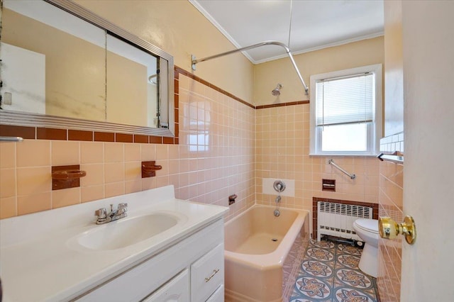 full bathroom with radiator heating unit, toilet, vanity, tile walls, and tiled shower / bath