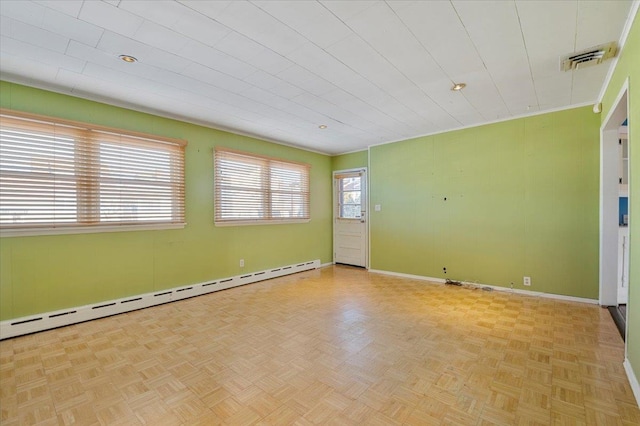 empty room with light parquet floors and baseboard heating