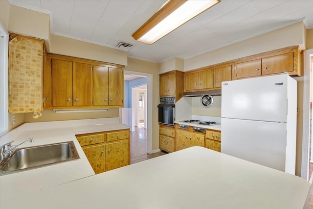 kitchen with kitchen peninsula, crown molding, white appliances, and sink