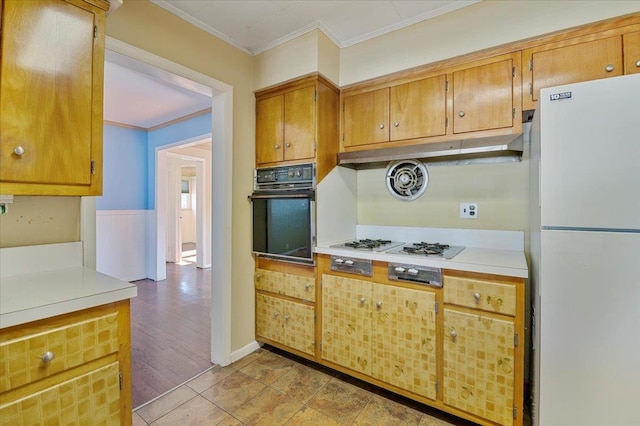 kitchen featuring crown molding, light tile patterned flooring, and white appliances