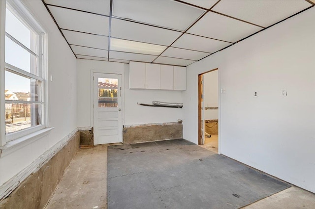 interior space featuring a paneled ceiling and a wealth of natural light