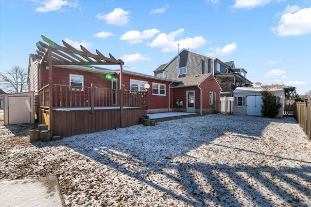 back of house with a pergola and a storage unit