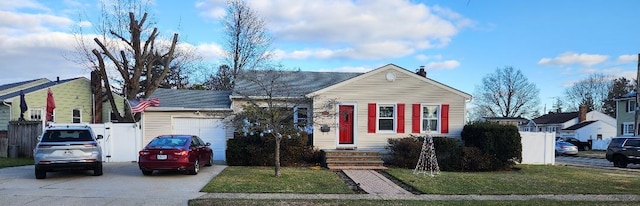 view of front of home featuring a front yard and a garage