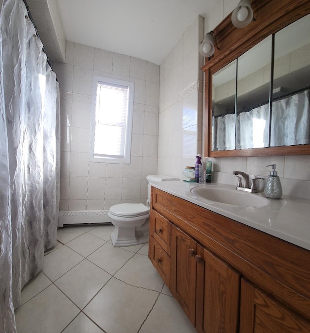 bathroom featuring vanity, tile patterned floors, toilet, baseboard heating, and tile walls