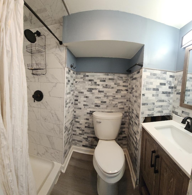 bathroom featuring curtained shower, vanity, wood-type flooring, and toilet