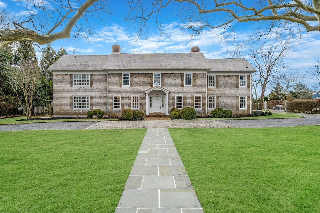 colonial home with a front yard