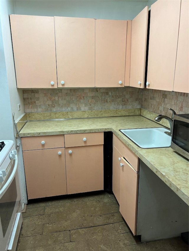 kitchen with decorative backsplash, sink, and white electric stove