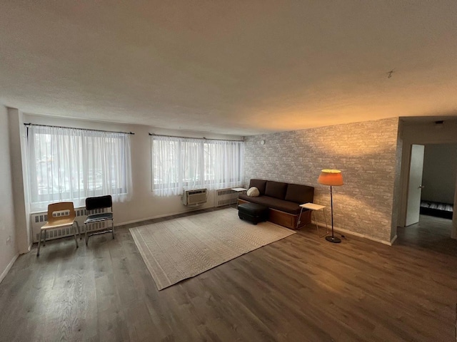 unfurnished living room featuring wood-type flooring and a wall mounted AC