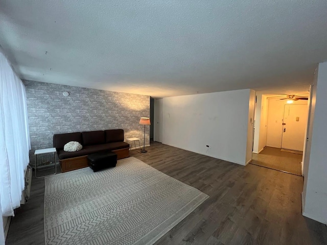 interior space with dark wood-type flooring and a textured ceiling