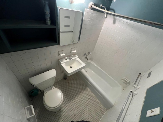 bathroom with tile patterned flooring, toilet, tile walls, and sink