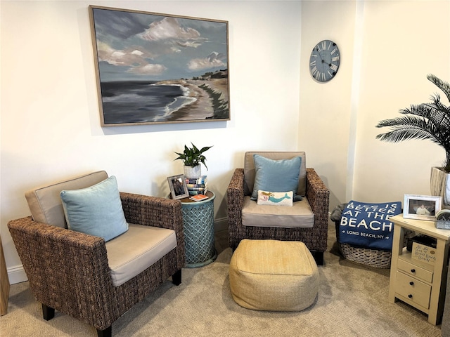 sitting room featuring light colored carpet