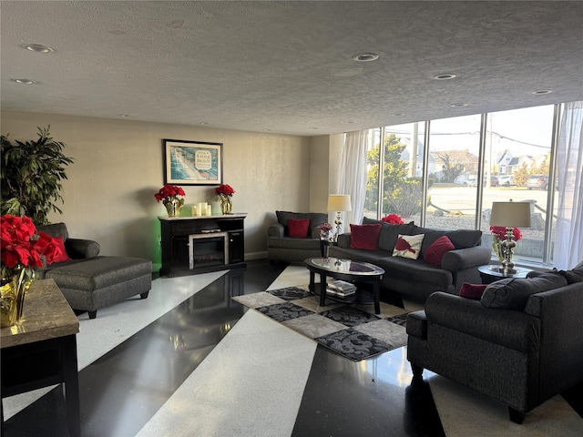 living room featuring floor to ceiling windows and a textured ceiling