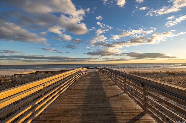 view of home's community featuring a beach view and a water view