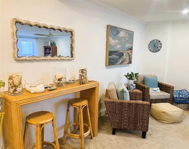living area with carpet floors, crown molding, and baseboards