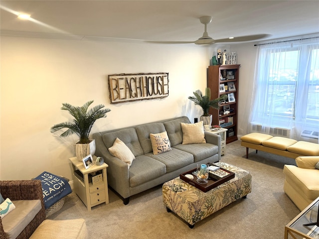 carpeted living room featuring ceiling fan and ornamental molding