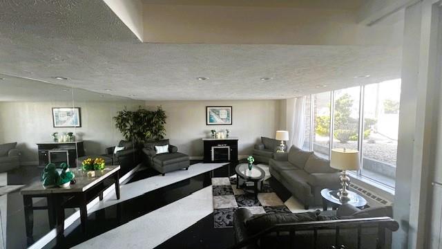 living area featuring a textured ceiling