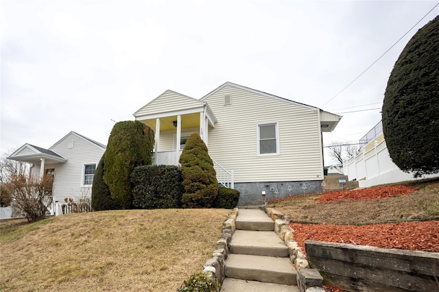 bungalow-style home with a front lawn