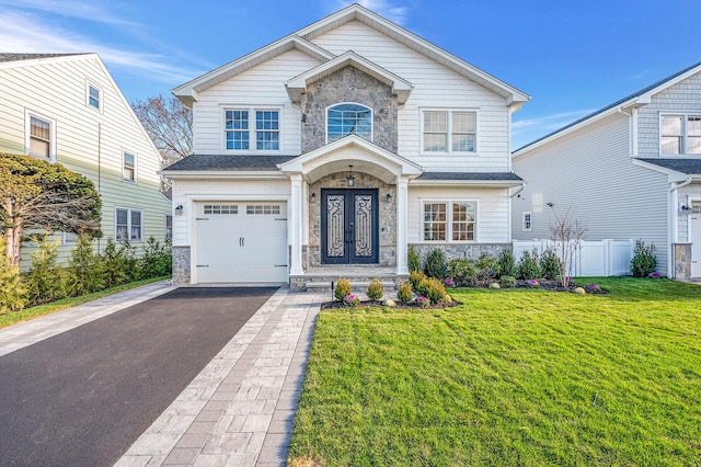 view of front facade with a front yard and a garage