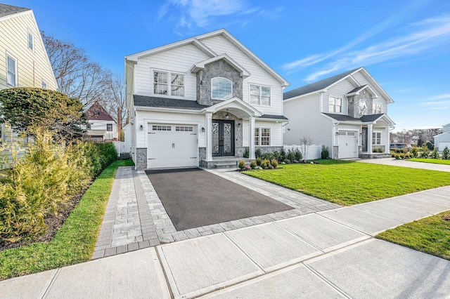 view of front facade with a front lawn and a garage