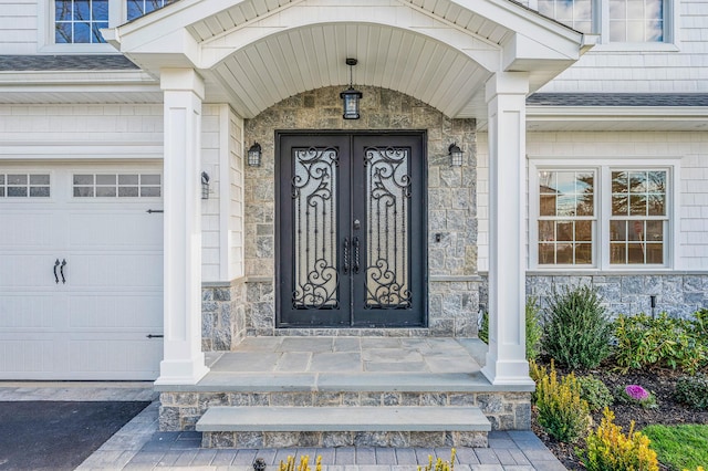 entrance to property with french doors and a porch