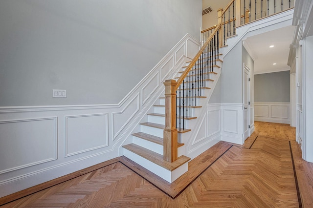 staircase featuring parquet floors