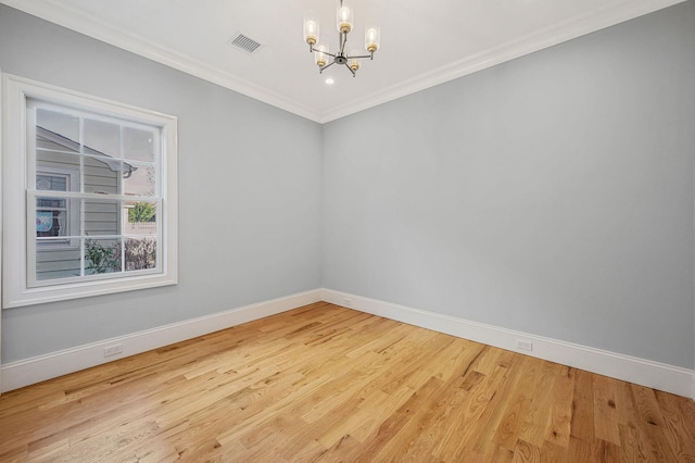 unfurnished room featuring a chandelier, wood-type flooring, and ornamental molding