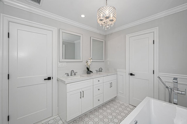 bathroom featuring vanity, crown molding, a bathtub, and a notable chandelier