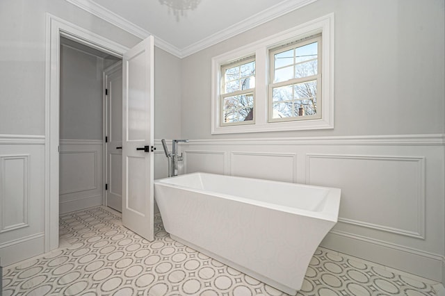 bathroom featuring ornamental molding and a tub