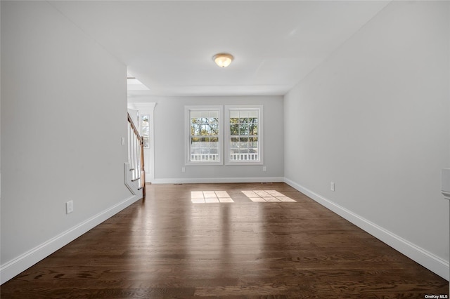 spare room with dark hardwood / wood-style floors