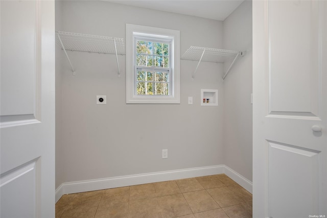 laundry area featuring tile patterned floors, baseboards, hookup for an electric dryer, hookup for a washing machine, and laundry area