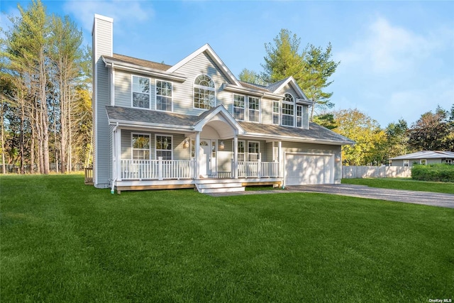 view of front of house featuring a porch, a front yard, a chimney, a garage, and driveway