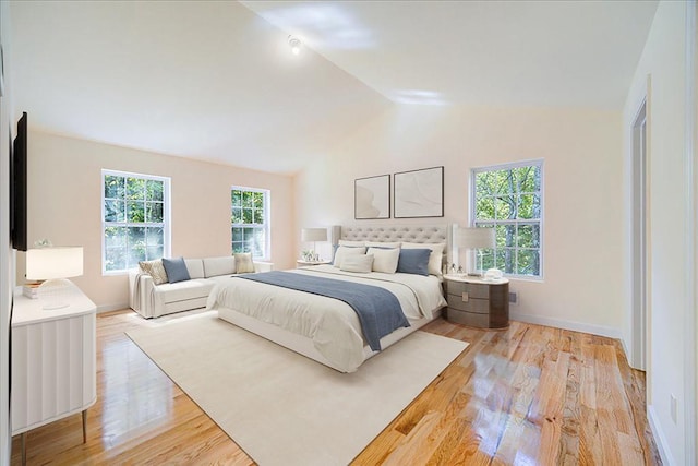 bedroom featuring vaulted ceiling and light hardwood / wood-style flooring