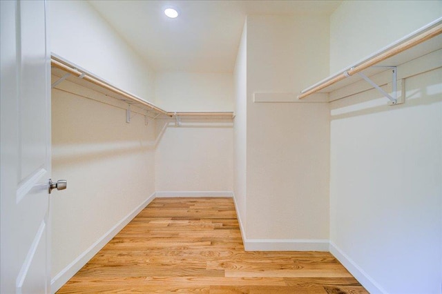 walk in closet featuring light hardwood / wood-style flooring