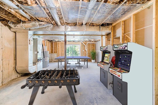 game room featuring water heater and concrete floors