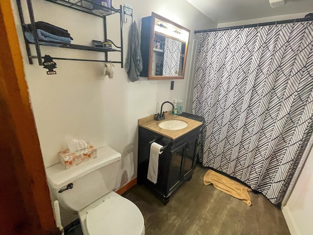 bathroom featuring vanity, toilet, and walk in shower